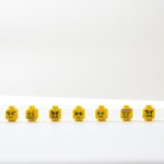 yellow and white round plastic toy with varying emotions